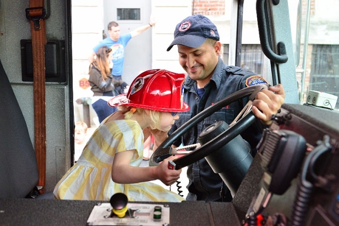 A little girl getting a chance to take the wheel at Engine 210 in Brooklyn 